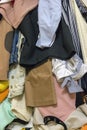 Vertical closeup of a pile of different used clothes as a background