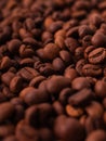 Vertical closeup of a pile of freshly-roasted brown coffee beans Royalty Free Stock Photo