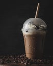 Vertical closeup of a plastic cup of cold coffee with a vanilla cream. Royalty Free Stock Photo
