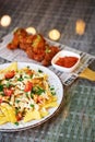 Vertical closeup of a plate of nachos and chicken nuggets served with a sauce Royalty Free Stock Photo