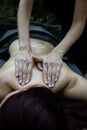 Vertical closeup of a professional relaxing back massage