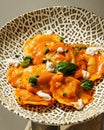 Vertical closeup of ricotta cheese ravioli on a plate with tiger patters