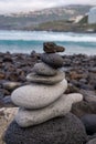 Vertical closeup of roundly shaped rocks stacked on top of each other on a beautiful beach