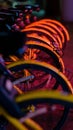 Vertical closeup of a row of bicycles parked on the street in the evening. Royalty Free Stock Photo