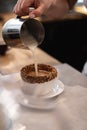 Vertical closeup shot of a barista making coffee with milk Royalty Free Stock Photo