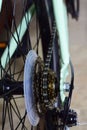 Vertical closeup shot of a bicycle wheel with chain, gears and drive discs. Royalty Free Stock Photo