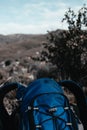 Vertical closeup shot of a blue hiking backpack in the mountains