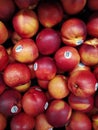 Vertical closeup shot of bright peaches at a market