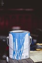 Vertical closeup shot of a bucket of blue paint