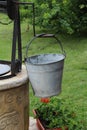 Vertical closeup shot of a bucket hanging on a well crank