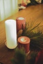 Vertical closeup shot of Christmas candles spreading a festive cheerful atmosphere