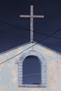 Vertical closeup shot of a church with a huge cross and storm in the background