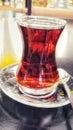 Vertical closeup shot of a cup of tea on a glass surface Royalty Free Stock Photo