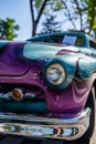 Vertical closeup shot of details on a shiny antique automobile