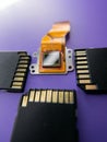 Vertical closeup shot of a digital camera Ccd sensor and black SD cards on a purple background Royalty Free Stock Photo