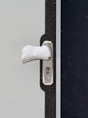 Vertical closeup shot of a door with snow on the door handle Royalty Free Stock Photo