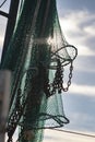 Vertical closeup shot of fishing nets and the cloudy sky in the background Royalty Free Stock Photo