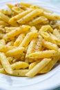 Vertical closeup shot of a gourmet dish of cheesy penne pasta