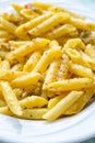 Vertical closeup shot of a gourmet dish of cheesy penne pasta