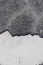 Vertical closeup shot of a gray floor with a cracked white tile Royalty Free Stock Photo