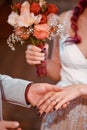 Vertical closeup shot of the hands of a newly married couple during the wedding Royalty Free Stock Photo