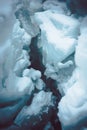 Vertical closeup shot of an ice crevasse in the snowy covered ground Royalty Free Stock Photo