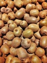 Vertical closeup shot of many kiwi fruits