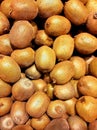 Vertical closeup shot of many kiwi fruits