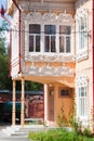Vertical closeup shot of an old traditional wooden house in pastel colors, Tomsk, Russia
