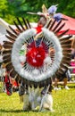 Vertical closeup shot of a person in a colorful Native Indian-American festive costume with feathers