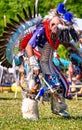 Vertical closeup shot of a person in a colorful traditional native Indian-American festive regalia