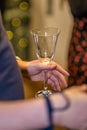 Vertical closeup shot of a person holding a wine glass during an event Royalty Free Stock Photo