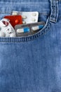 Vertical closeup shot of pills and capsules in a jean pocket Royalty Free Stock Photo