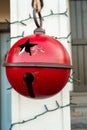 Vertical closeup shot of a red rusty bulb hanging outside at Christmas time Royalty Free Stock Photo