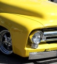 Vertical closeup shot of a retro bright yellow car