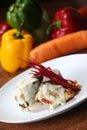 Vertical closeup shot of roast chicken with white sauce on a table with vegetables Royalty Free Stock Photo