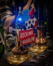 Vertical closeup shot of a rocking rudolph beer pump in a busy London pub