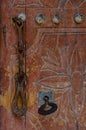 Vertical closeup shot of the rusty door handle and the door lock  with the key installed in it Royalty Free Stock Photo