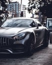 Vertical closeup shot of a shiny black luxurious car in the middle of a street Royalty Free Stock Photo