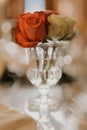 Vertical closeup shot of short white and red roses in a small glass vase Royalty Free Stock Photo