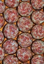 Vertical closeup shot of slices of sausage arranged next to each other