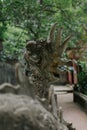 Vertical closeup shot of a statue of a dragon in the park during daytime