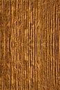 Vertical closeup shot of textural details of a patterned brown wall