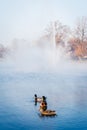 Vertical closeup shot of three cute ducklings swimming in the water Royalty Free Stock Photo