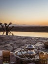 Vertical closeup shot of a typical Moroccan mint tea set on the table in  Agafay desert, Marrakech Royalty Free Stock Photo