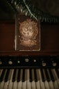 Vertical closeup shot of a vintage piano and a sheet music book that says Triumphant Songs Royalty Free Stock Photo