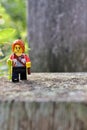 Vertical closeup shot of a woman lego figure on a stone outdoors in Greenville, United States Royalty Free Stock Photo