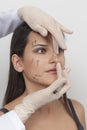 Vertical closeup shot of a woman preparing her face for a plastic surgery  procedure  professional Royalty Free Stock Photo