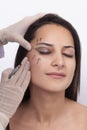 Vertical closeup shot of a woman preparing her face for a plastic surgery  procedure  professional Royalty Free Stock Photo