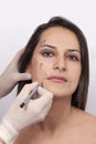 Vertical closeup shot of a woman preparing her face for a plastic surgery  procedure  professional Royalty Free Stock Photo